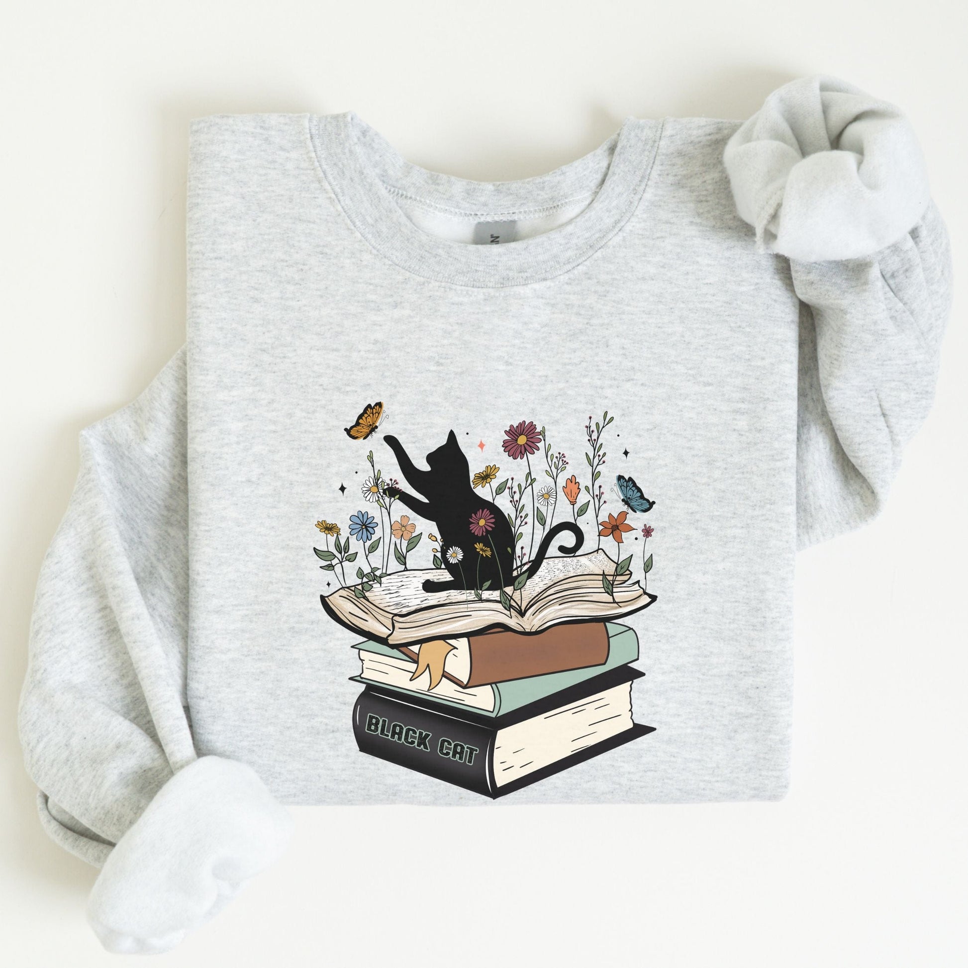 Gray sweatshirt with a black cat and books design on a white background
