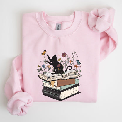 Pink sweatshirt with a cat and book design on a white background