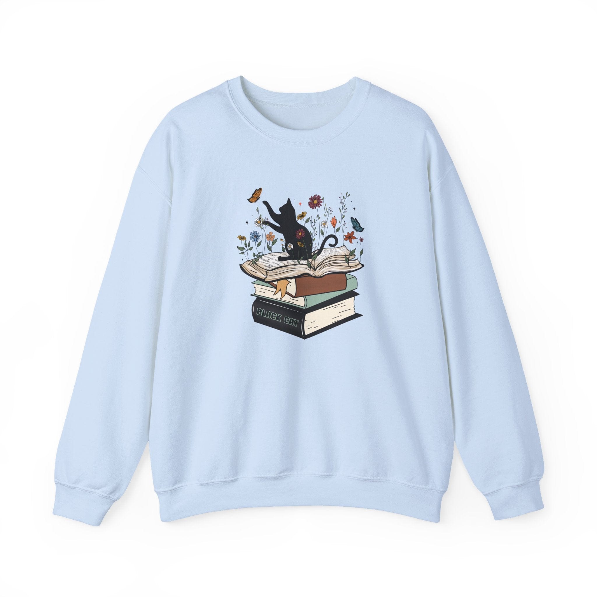 Light blue sweatshirt with a graphic of a cat on books and flowers on a white background