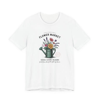 White t-shirt with 'Flower Market' graphic featuring a watering can and flowers on a white background