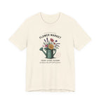 Beige t-shirt with floral design and text on a white background