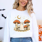Person wearing a white sweatshirt with a ghost and mushroom design.