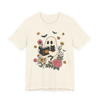 Beige t-shirt with a ghost reading a book and black cat design on a white background
