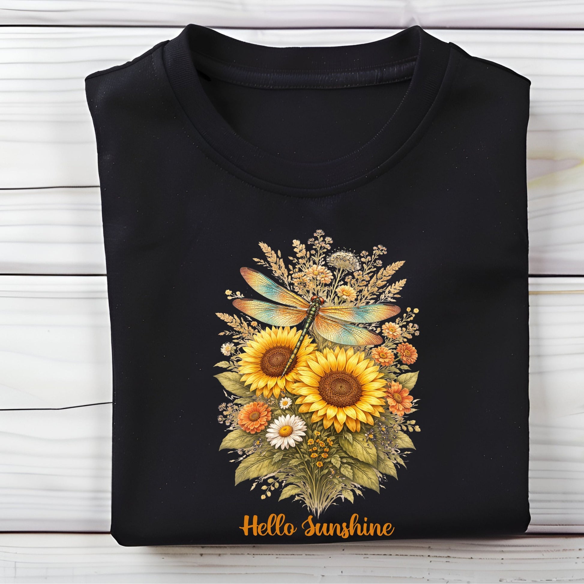 Black t-shirt with a floral design and 'Hello Sunshine' text on a wooden surface