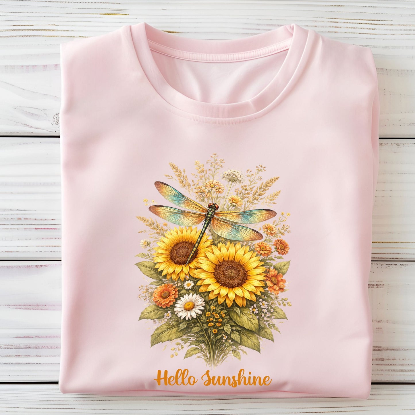 Pink t-shirt with floral design and 'Hello Sunshine' text on a wooden surface