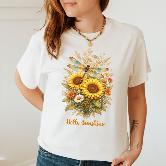 Person wearing a white t-shirt with a floral design and 'Hello Sunshine' text.