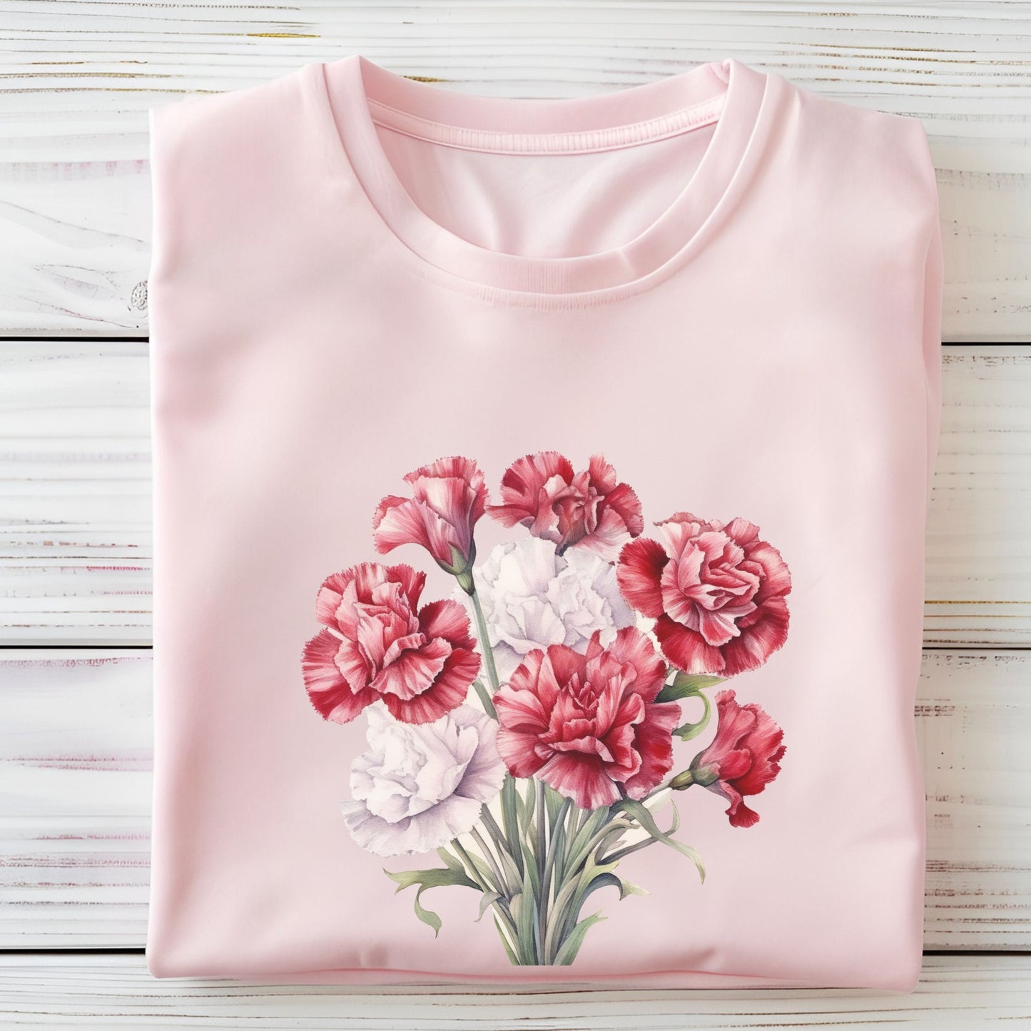 Pink t-shirt with a floral design on a wooden surface