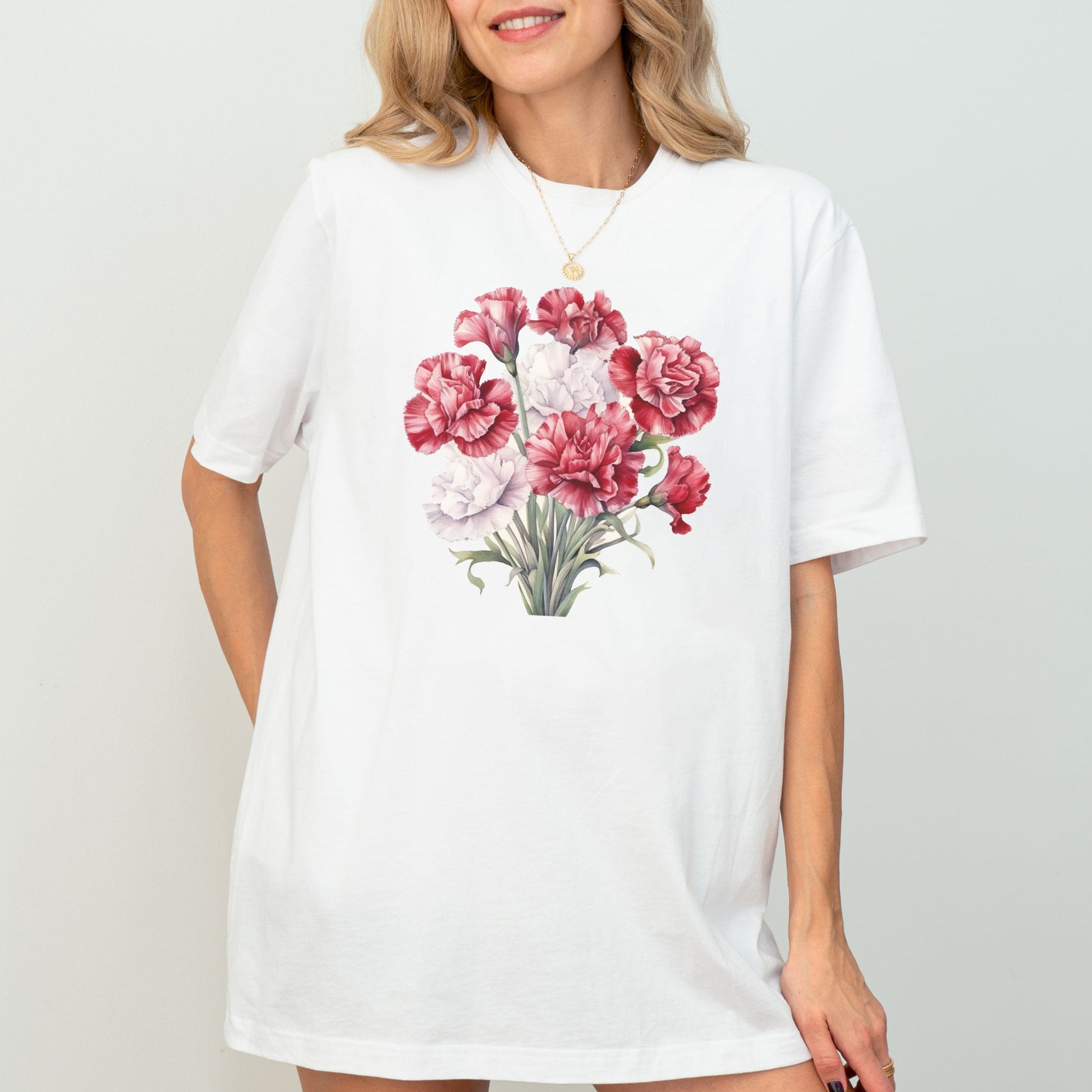 Woman wearing a white t-shirt with a floral design on a plain background