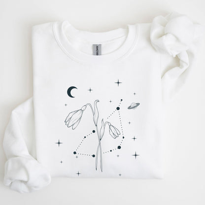 White sweatshirt with black floral and celestial design on a light background