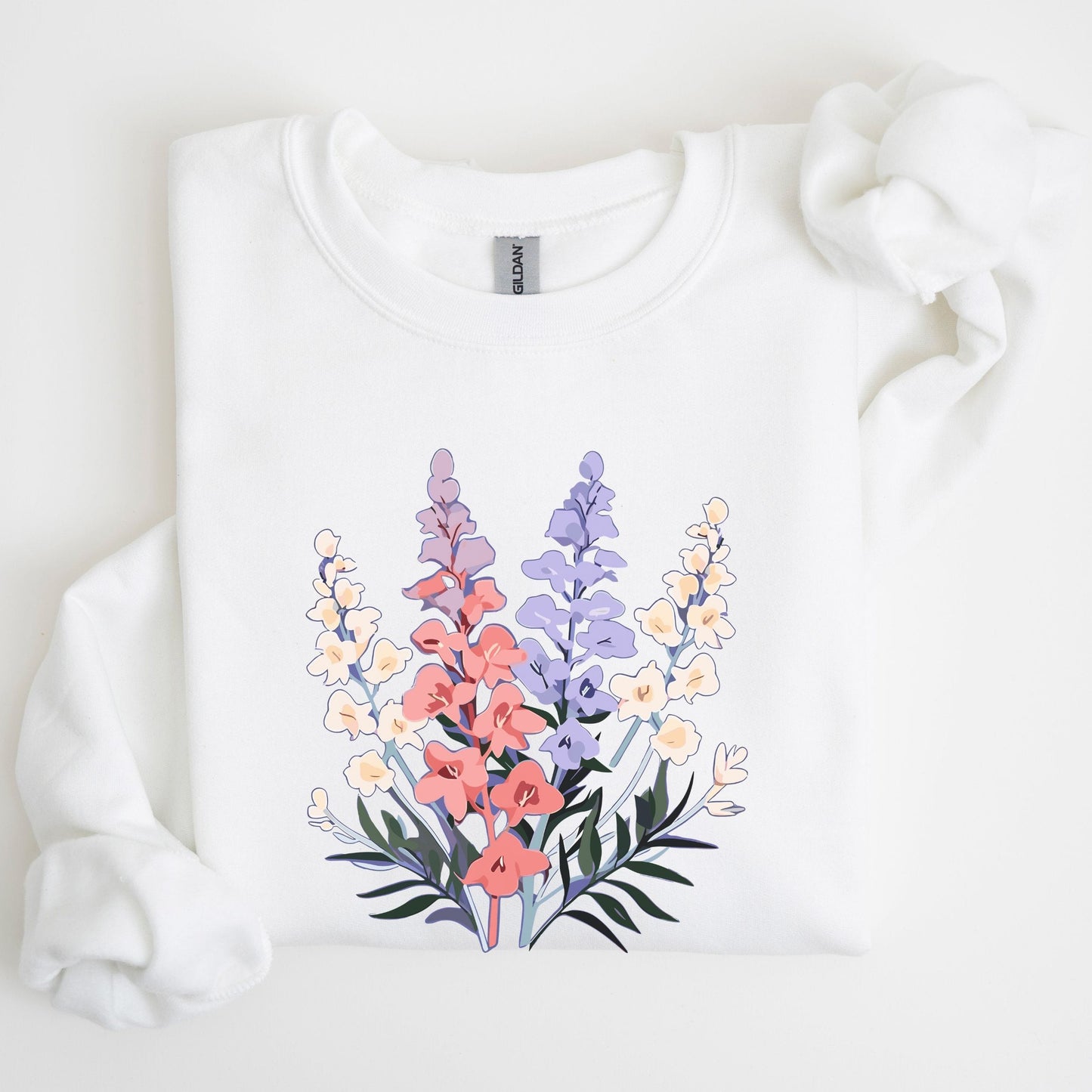 White sweatshirt with a colorful floral design on a light background