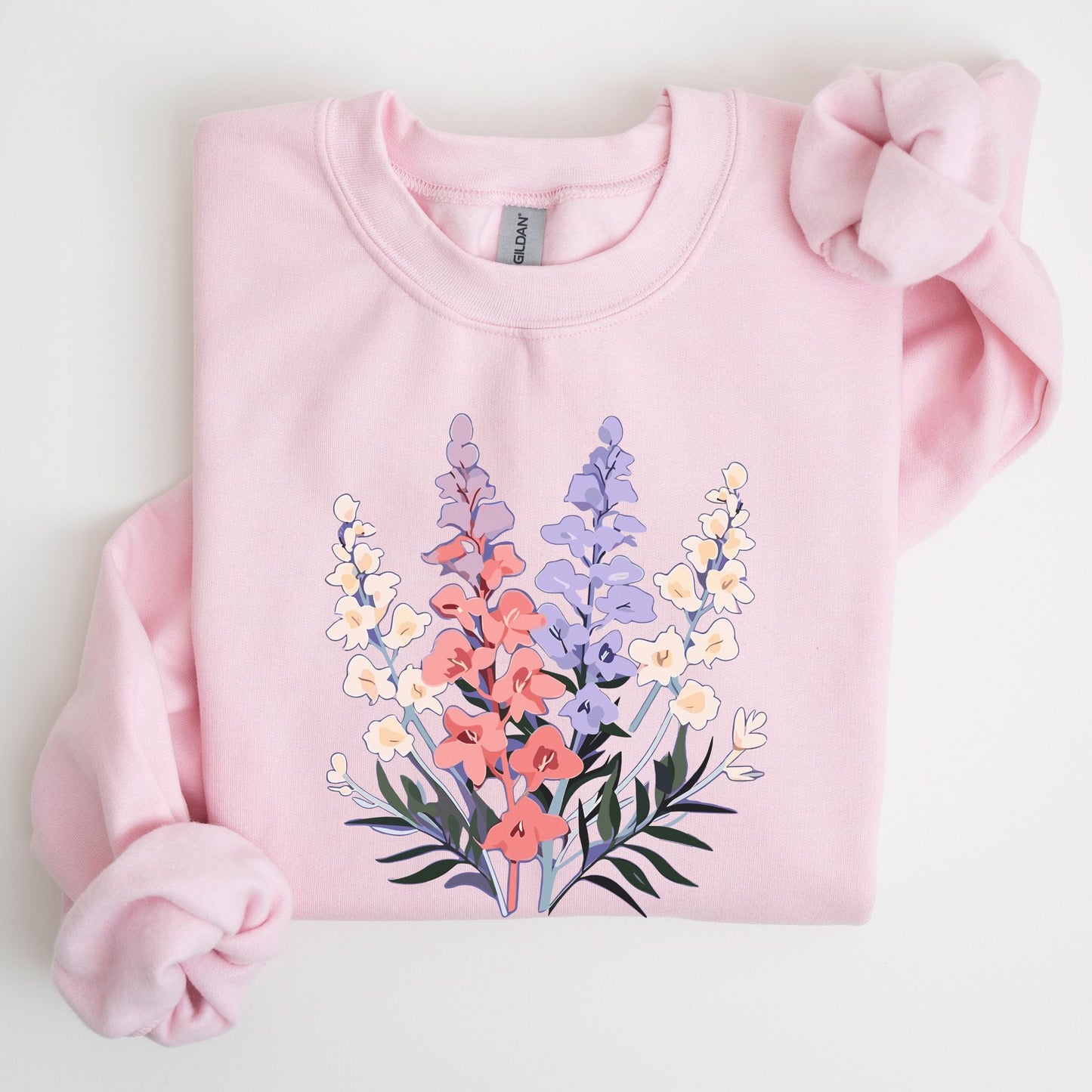 Pink sweatshirt with floral design on a light gray background