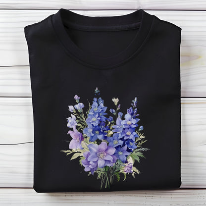 Black t-shirt with a blue floral design on a wooden surface