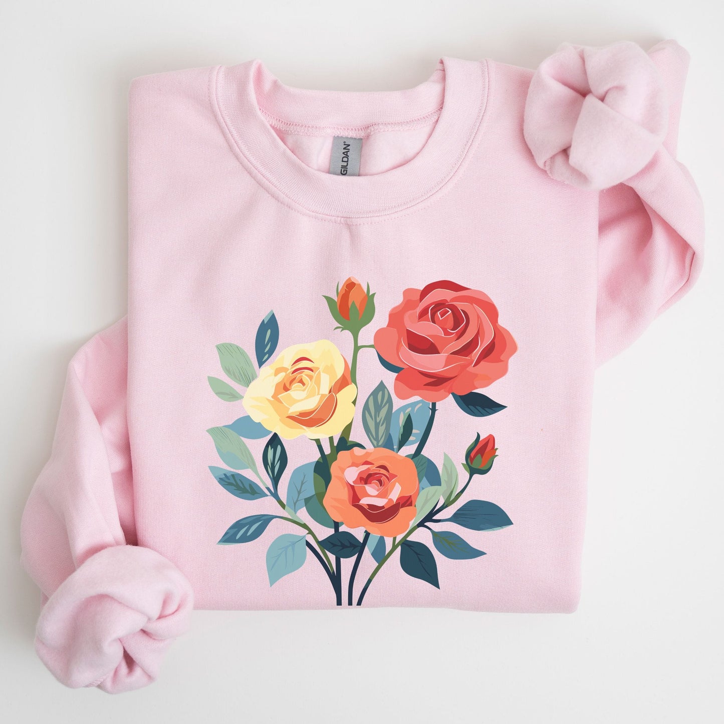 Pink sweatshirt with floral design on a light gray background