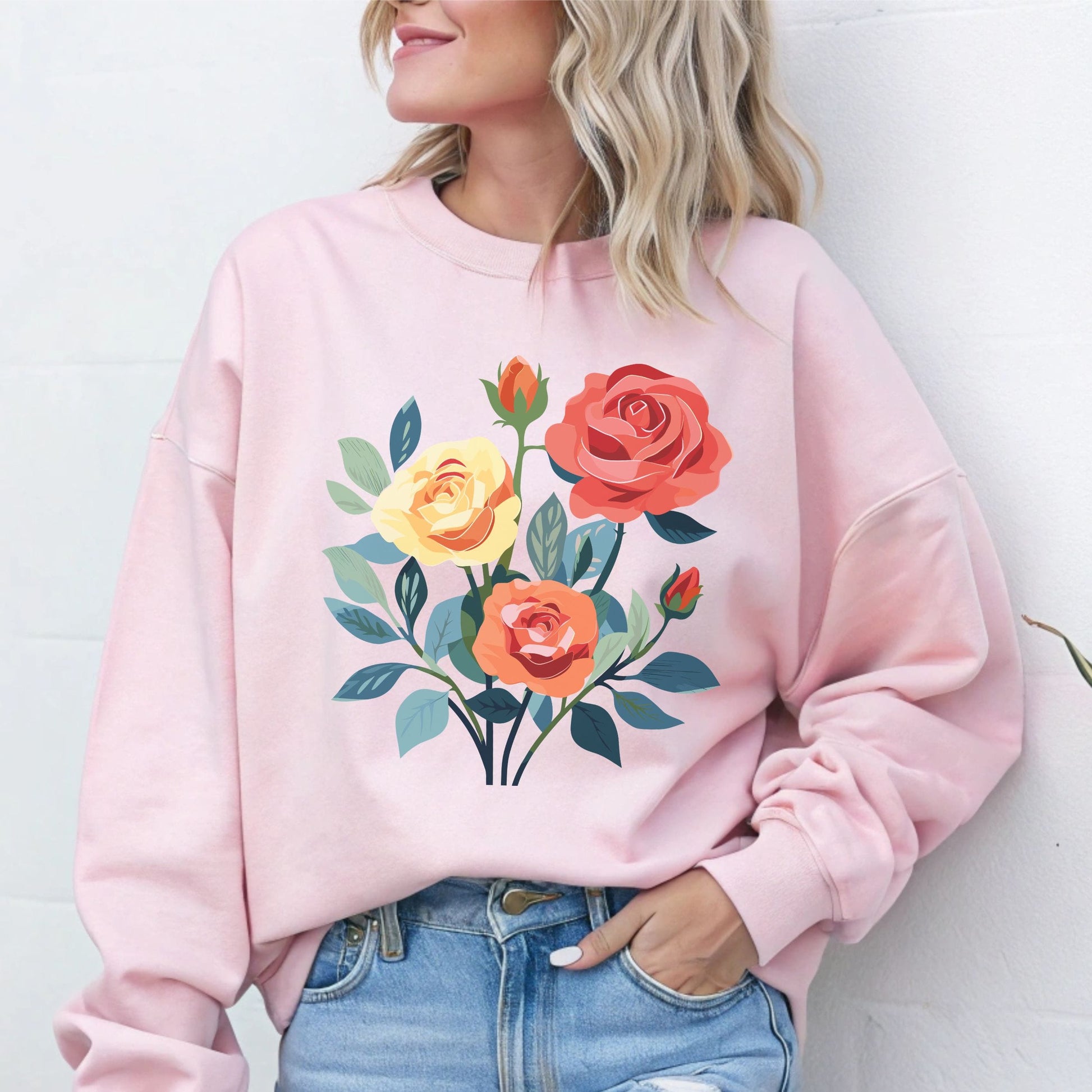 Person wearing a pink sweatshirt with floral design against a white background