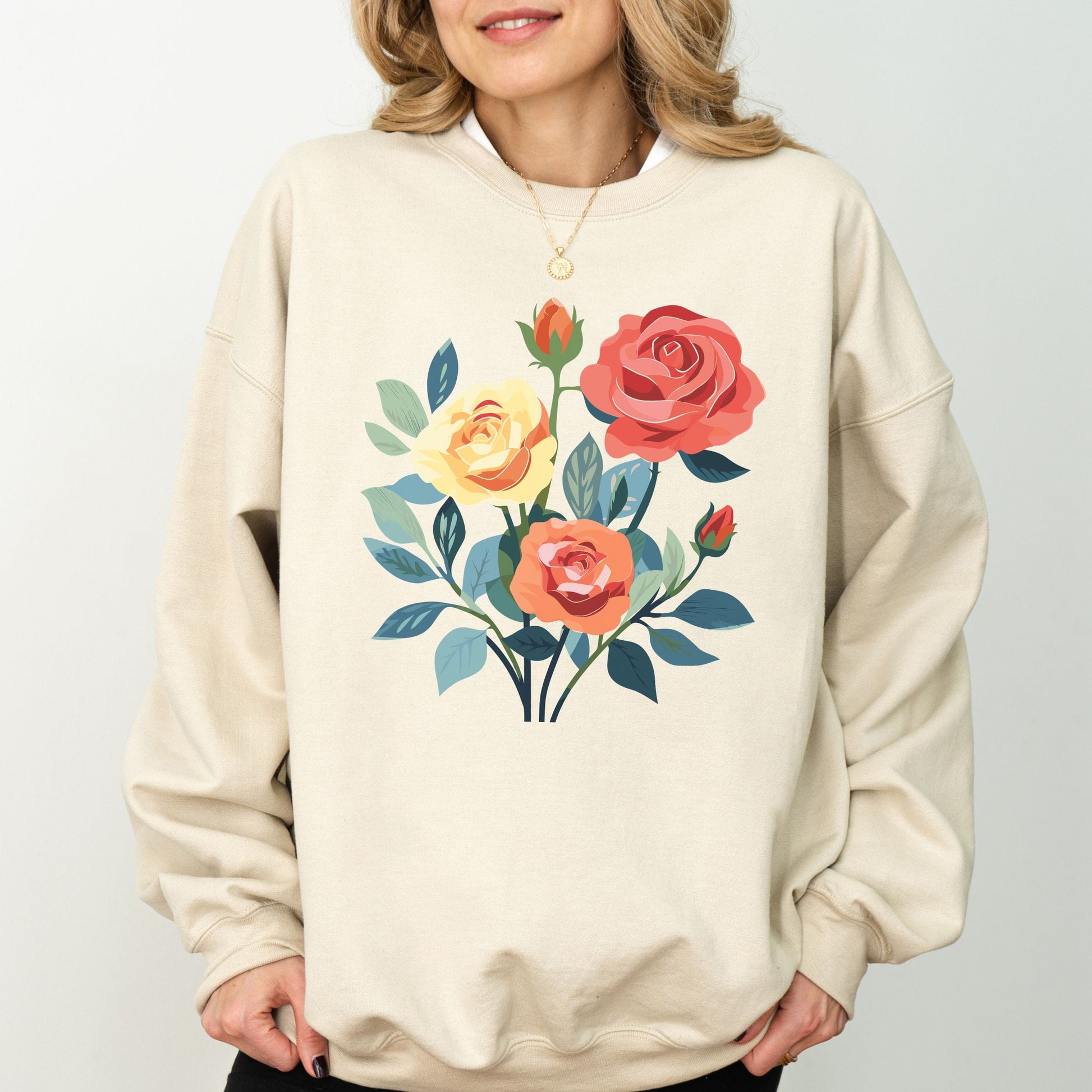 Beige sweatshirt with floral design worn by a person on a plain background