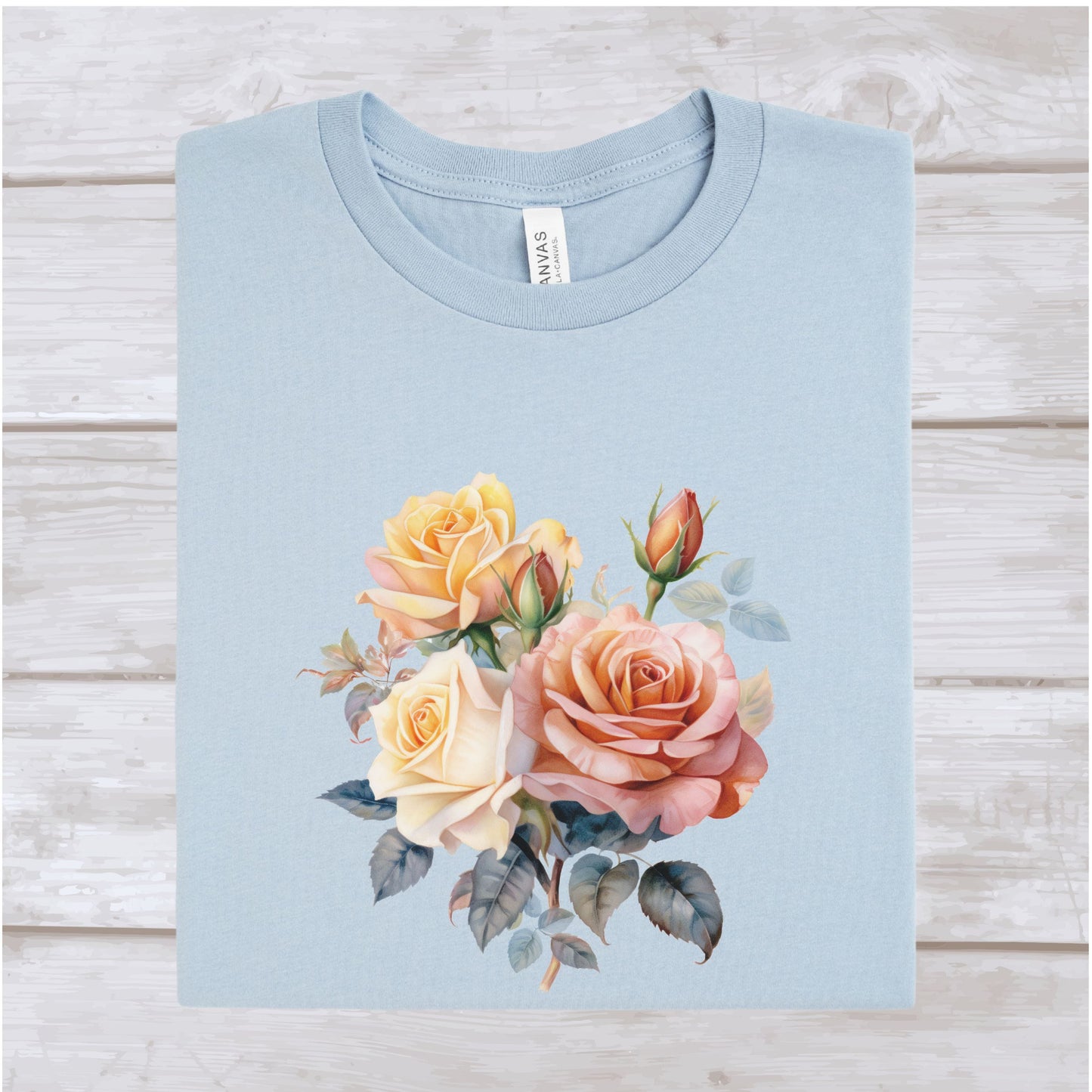 Light blue t-shirt with floral design on a wooden surface