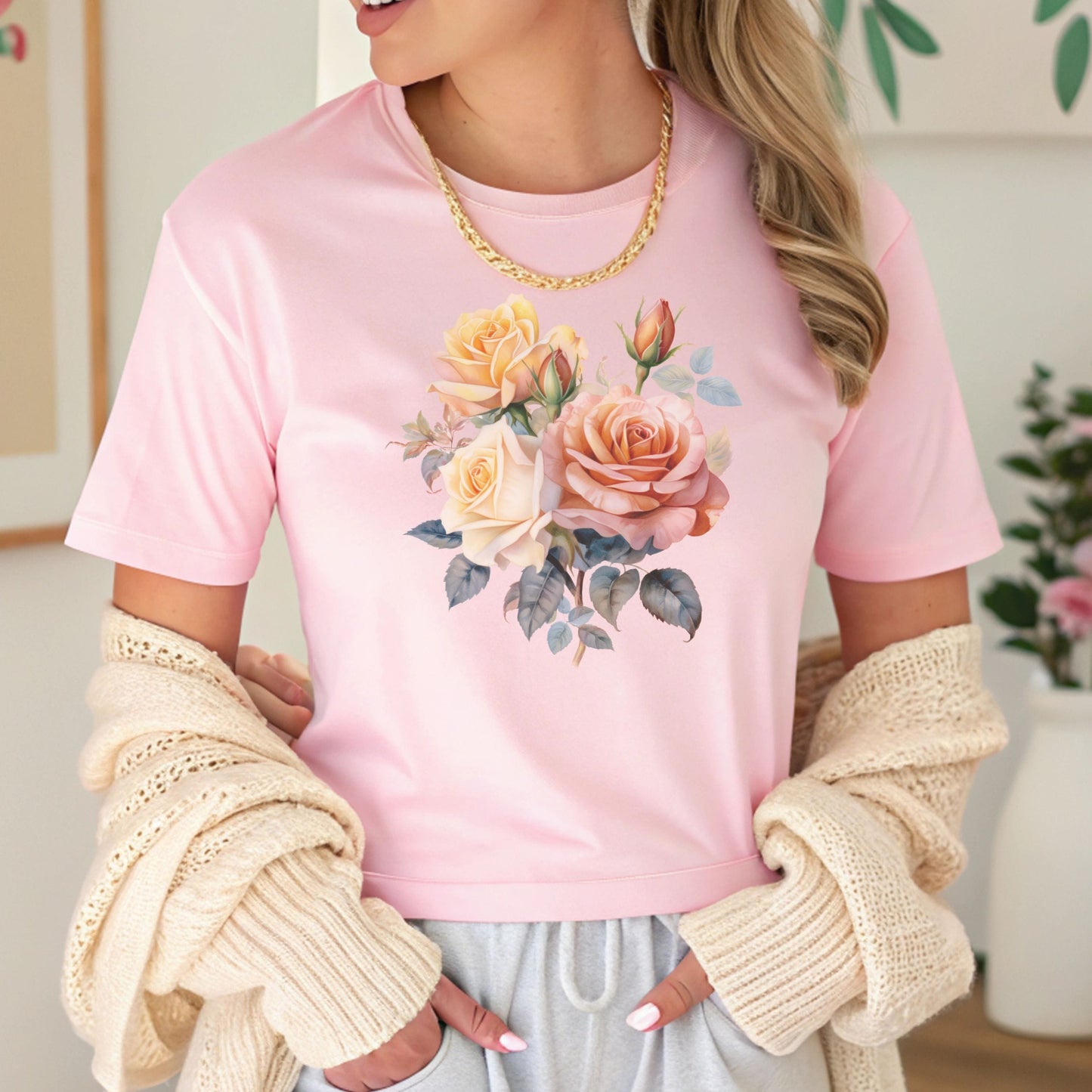 Person wearing a pink t-shirt with a floral design