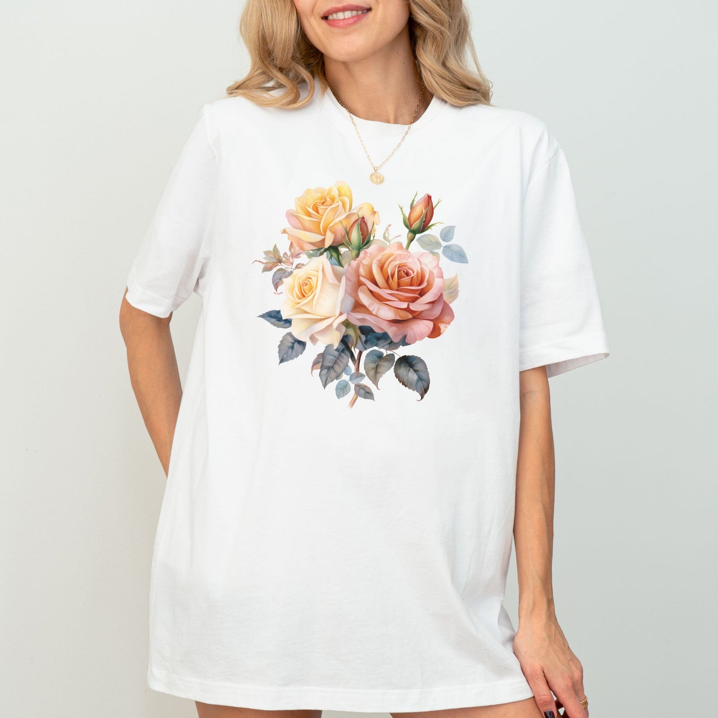 Woman wearing a white t-shirt with a floral design on a plain background