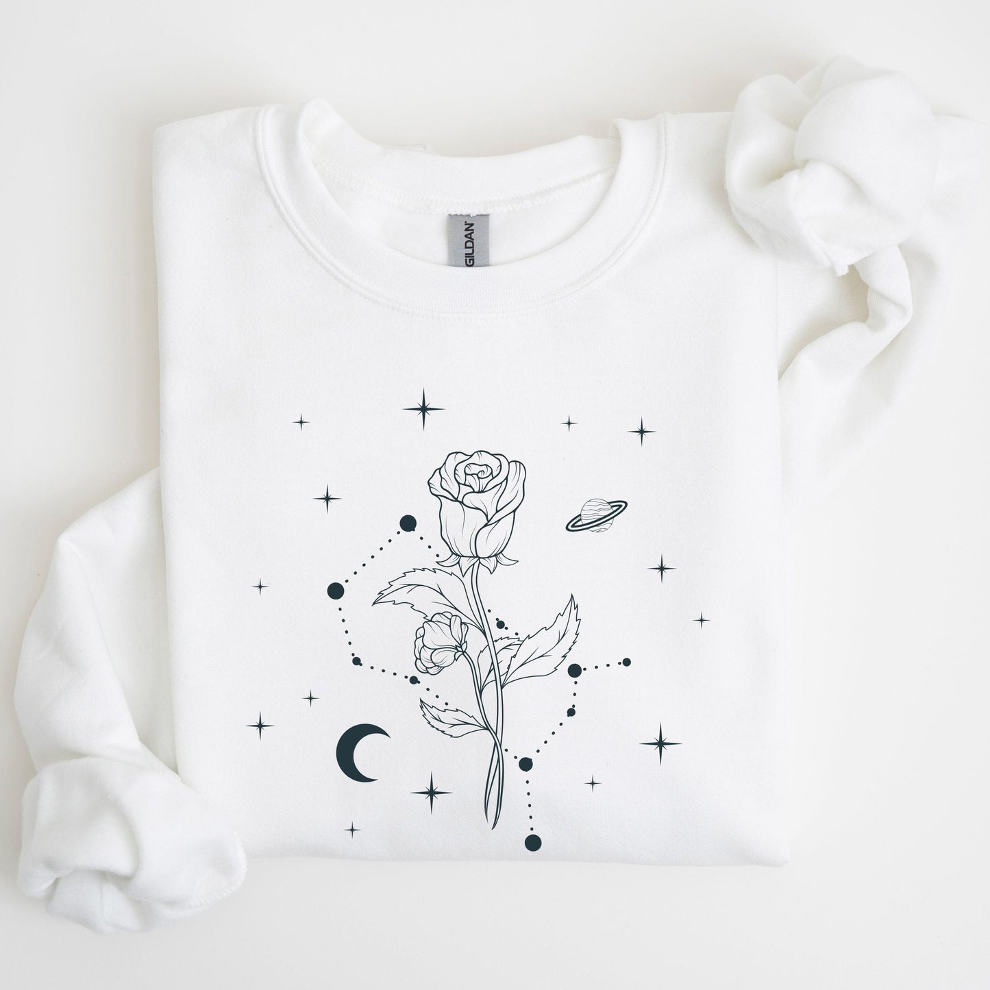 White sweatshirt with black rose and star design on a light background
