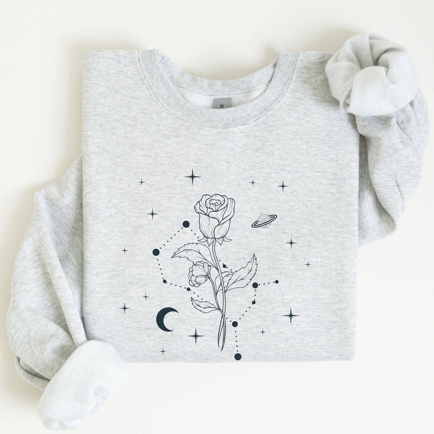 Gray sweatshirt with black floral and celestial design on a white background