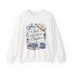 White sweatshirt with book-themed design and text 'Just one more chapter' on a white background