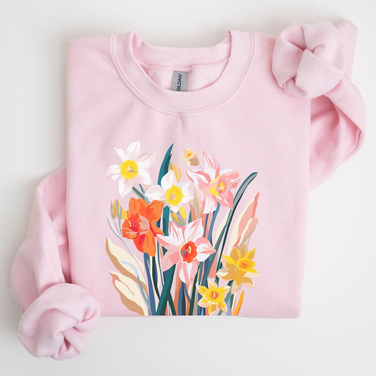 Pink sweatshirt with floral design on a white background