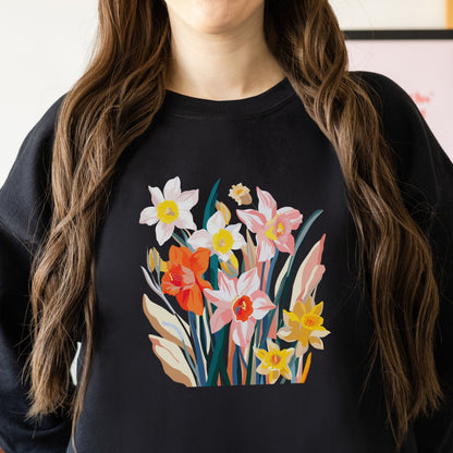 Person wearing a black sweatshirt with a colorful floral design.