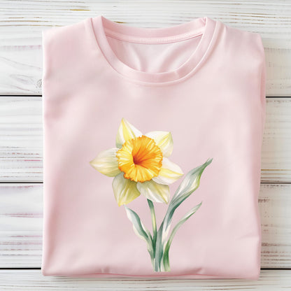 Pink t-shirt with a yellow flower design on a wooden surface