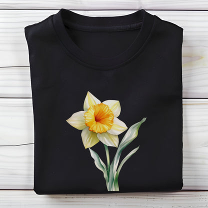 Black shirt with a yellow flower design on a wooden surface