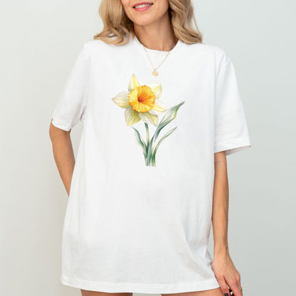 Woman wearing a white t-shirt with a yellow flower design on a plain background