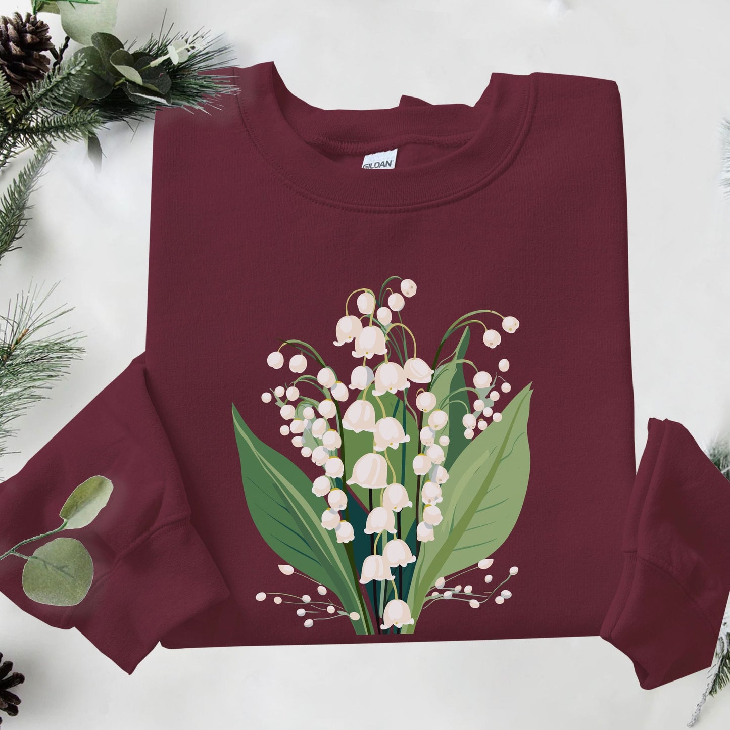Maroon sweatshirt with floral design on a white background