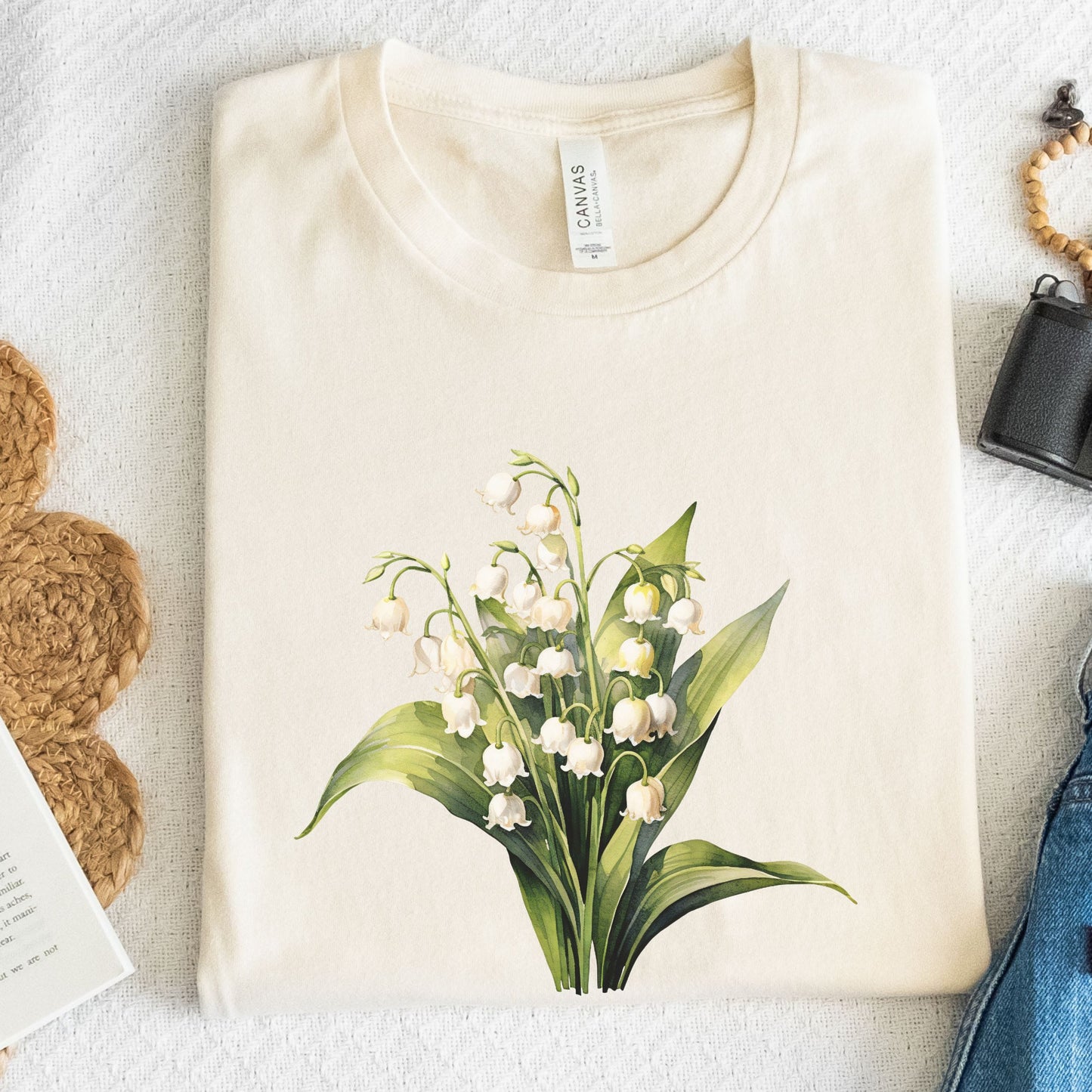 Beige t-shirt with a floral design on a textured surface