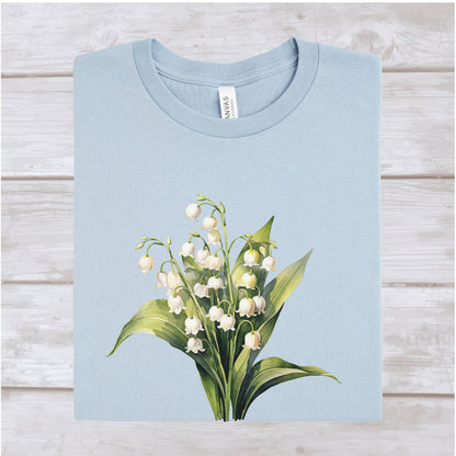 Light blue t-shirt with a floral design on a wooden surface