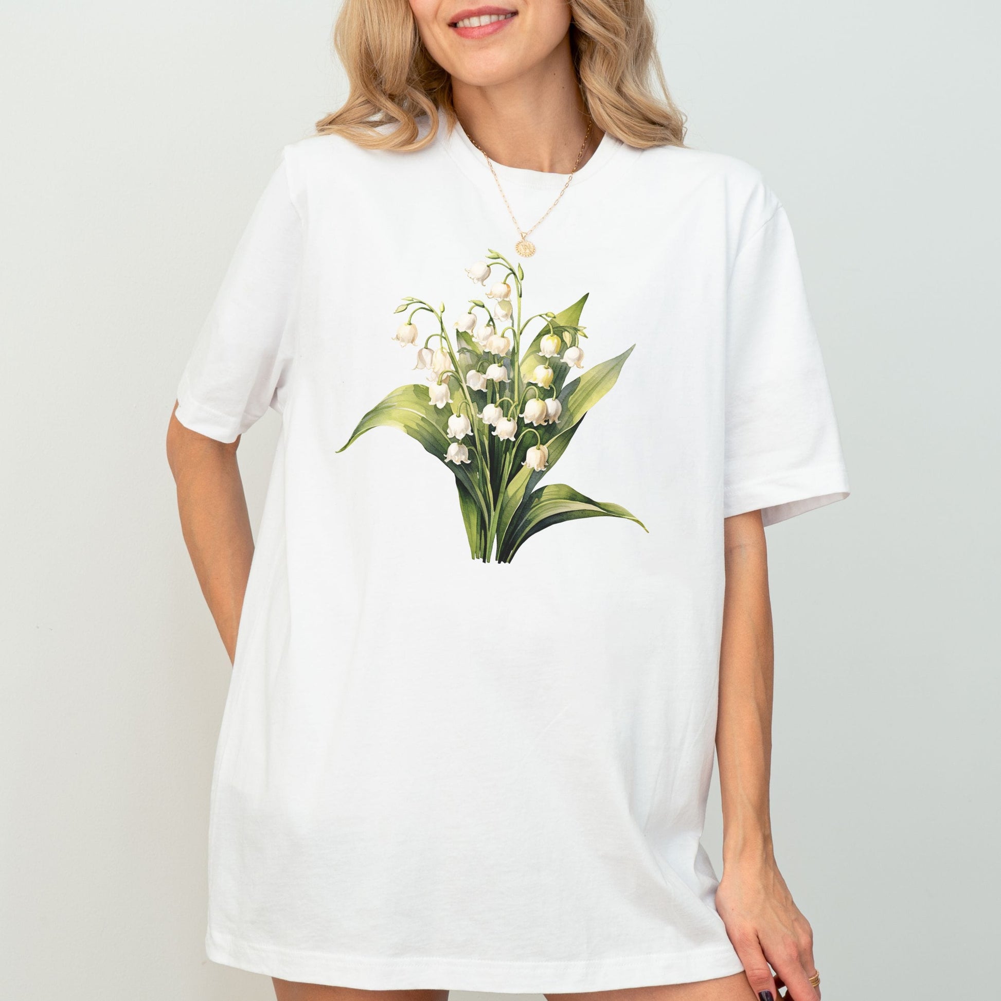 White t-shirt with floral design worn by a model on a plain background