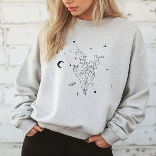 Person wearing a grey sweatshirt with floral celestial design.