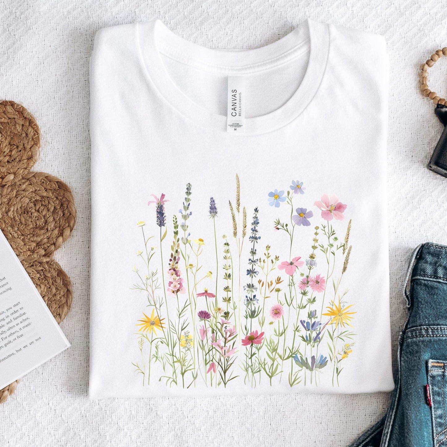 White t-shirt with floral design on a light background