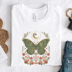 White t-shirt with a moth design on a textured surface