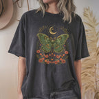 Person wearing a dark heather grey t-shirt with a green moth design against a neutral background