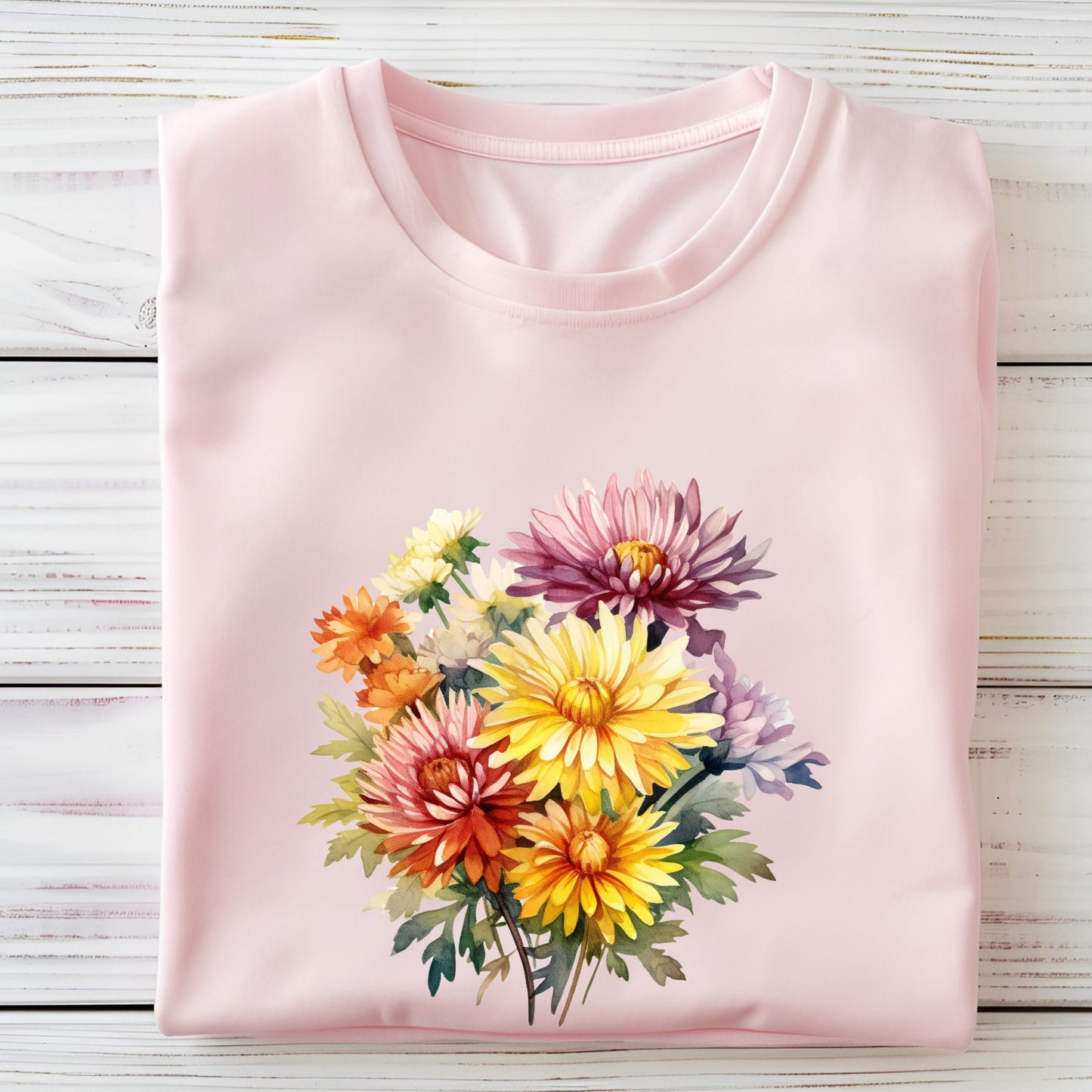 Pink t-shirt with a colorful floral design on a wooden surface
