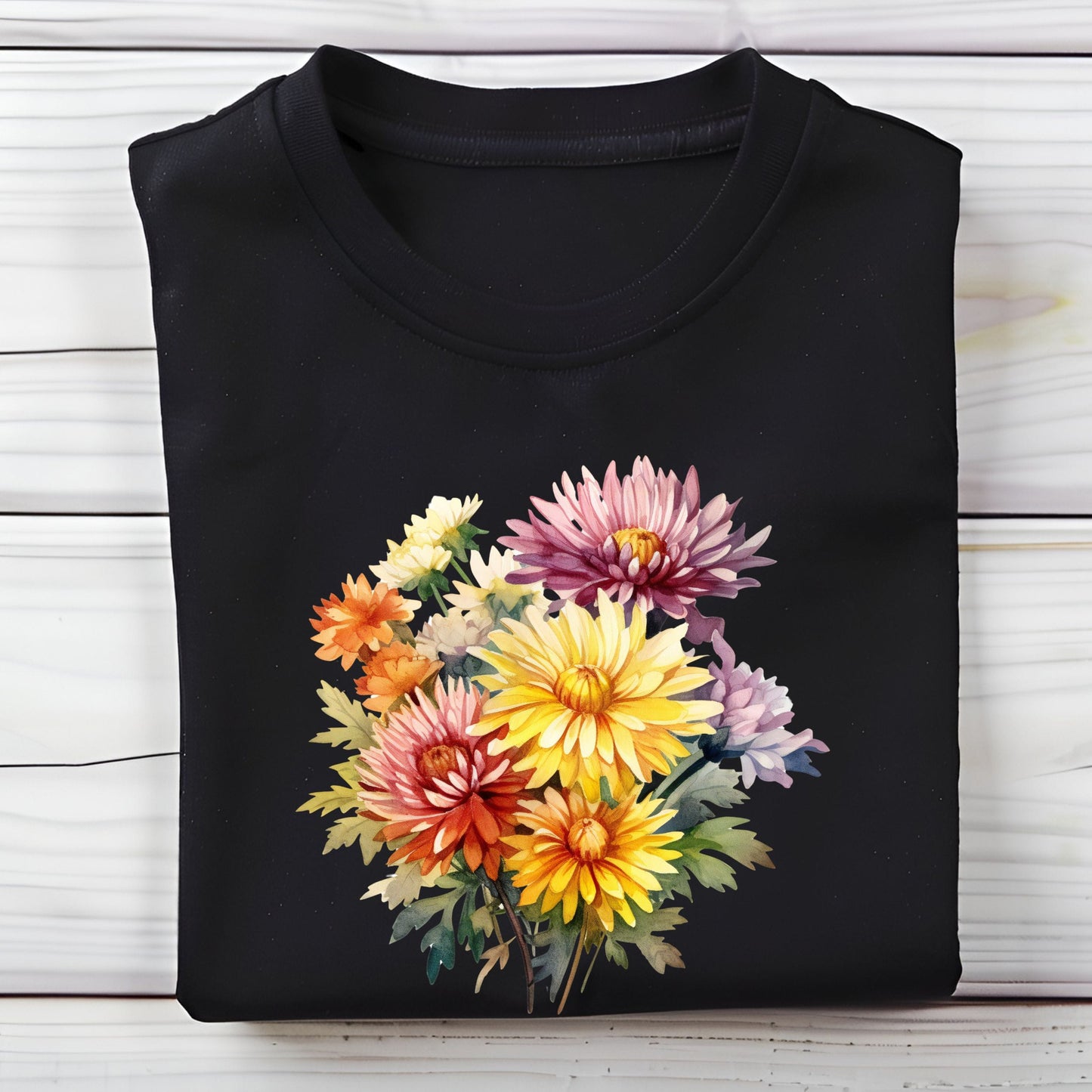 Black t-shirt with colorful flower design on a wooden surface
