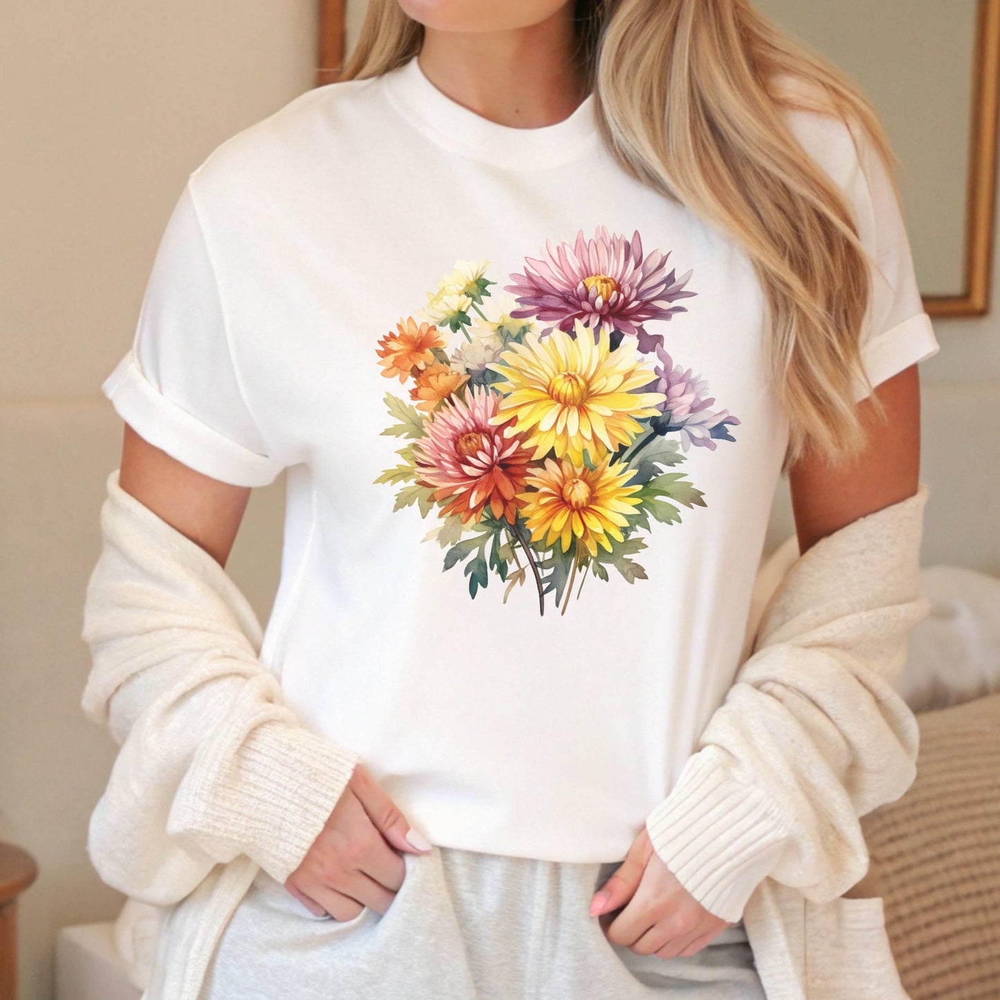 Person wearing a white t-shirt with a colorful floral design.