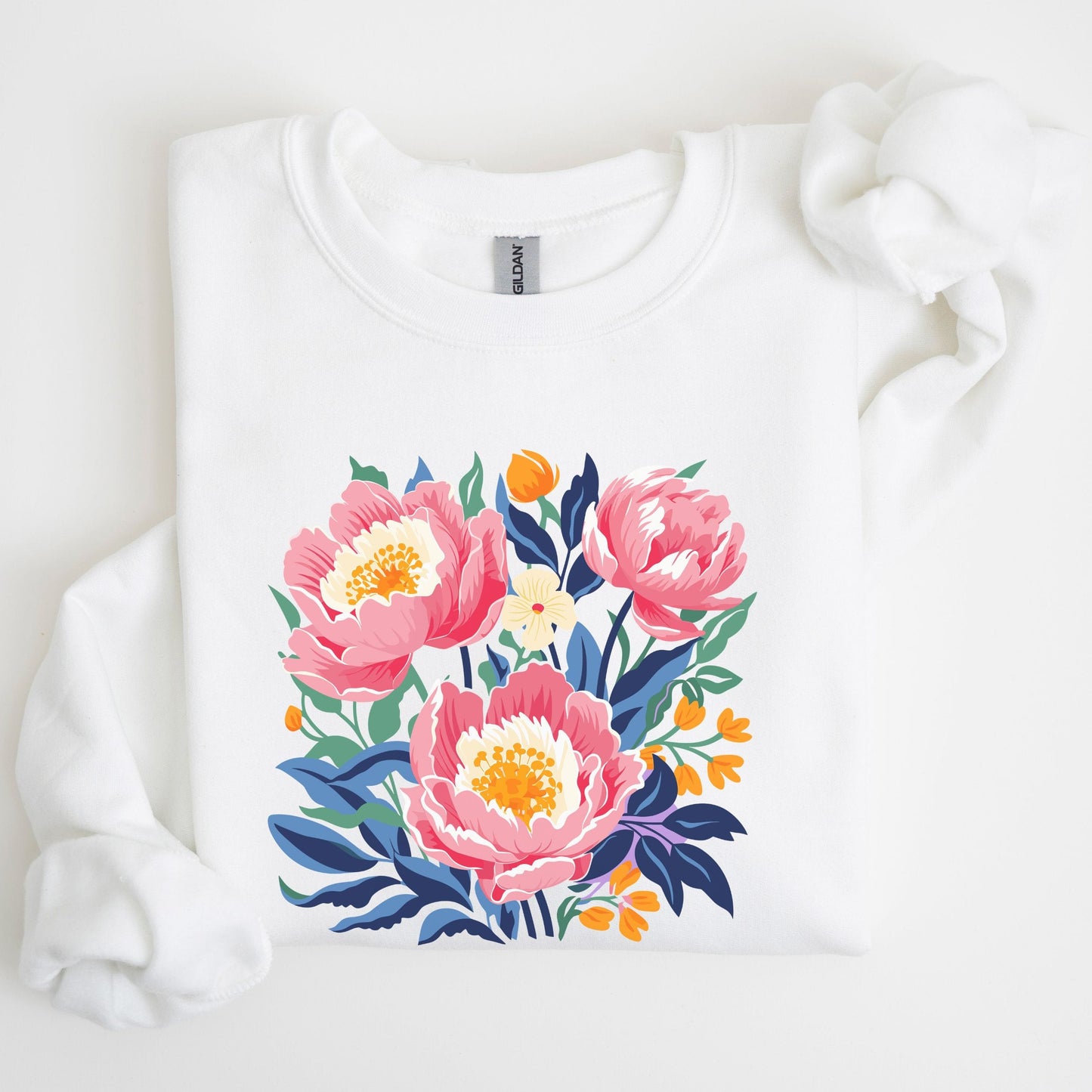 White sweatshirt with pink floral design on a light background