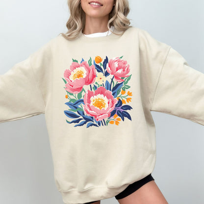 Person wearing a cream sweatshirt with a floral design on a plain background