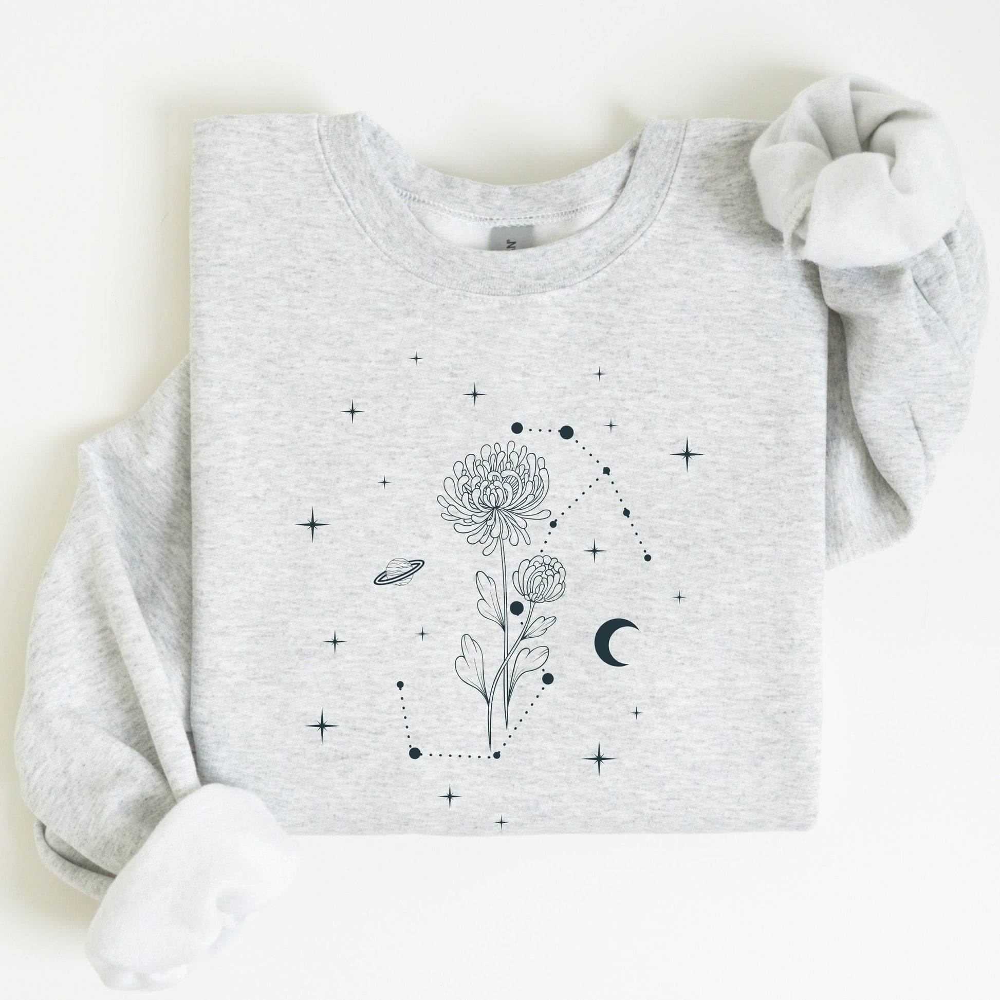 Gray sweatshirt with floral and celestial design on a white background