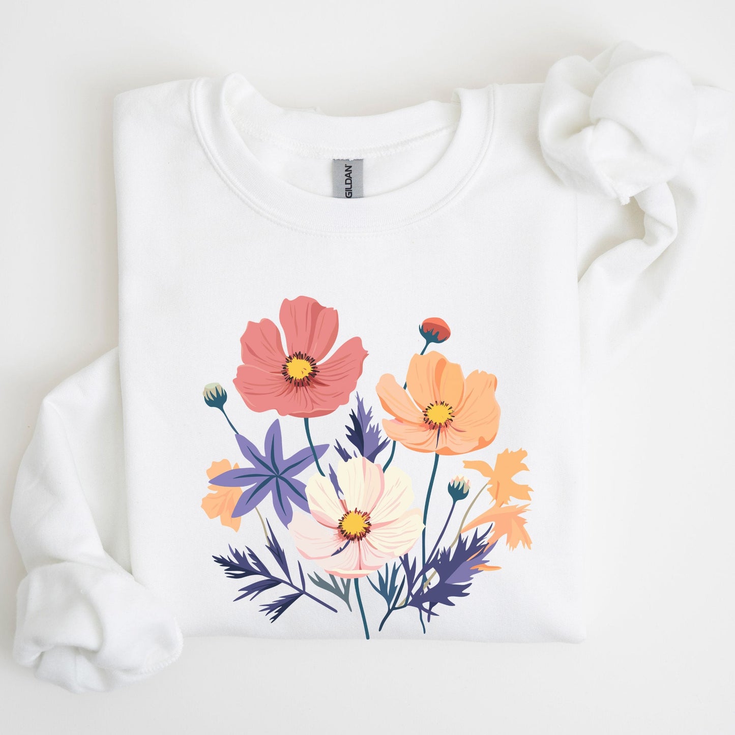 White sweatshirt with colorful floral design on a light background