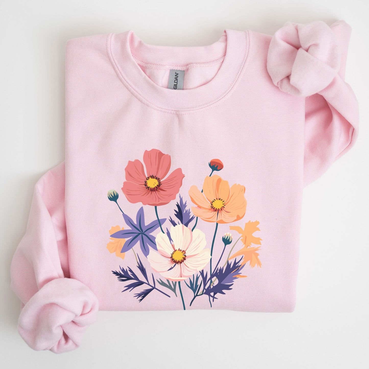 Pink sweatshirt with floral design on a light gray background