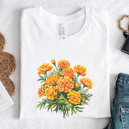 White t-shirt with a yellow floral design on a light gray surface.