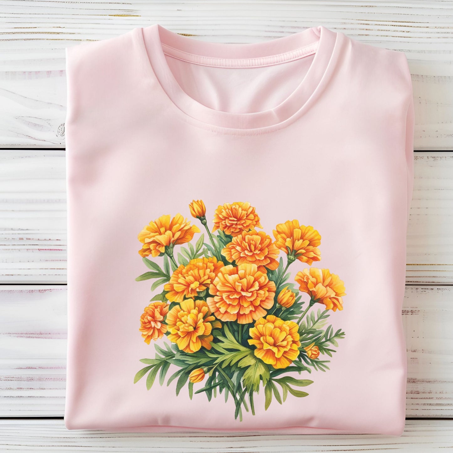 Pink t-shirt with a yellow floral design on a wooden surface