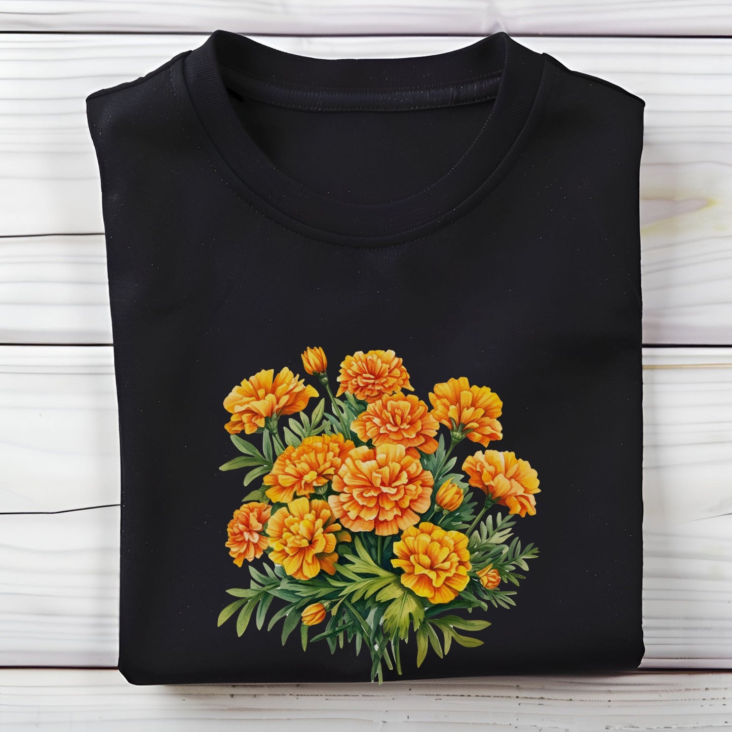 Black t-shirt with orange floral design on a wooden surface