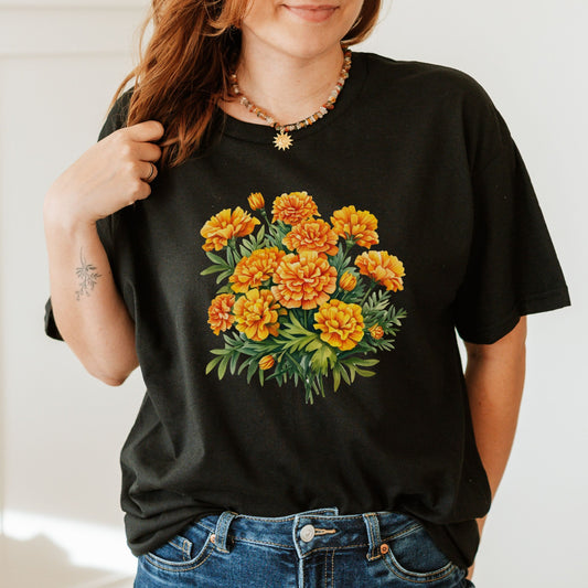 Person wearing a black t-shirt with a floral design on a plain background